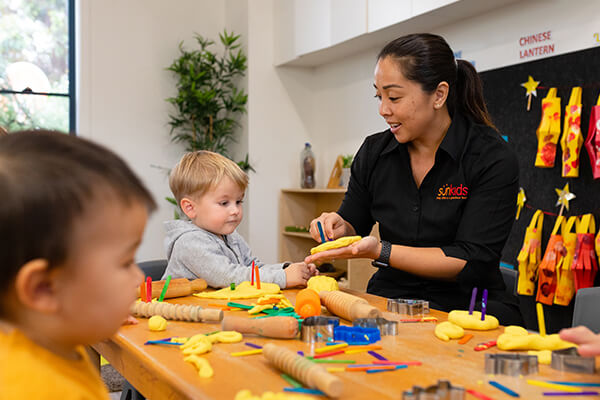 SK-Section-Educators3 Happy parent in Sunkids classroom smiling