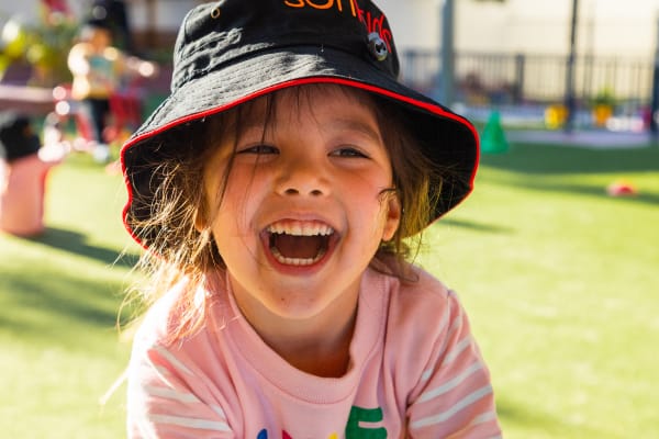 test-sunkids52 Young happy girl at Sunkids smiling